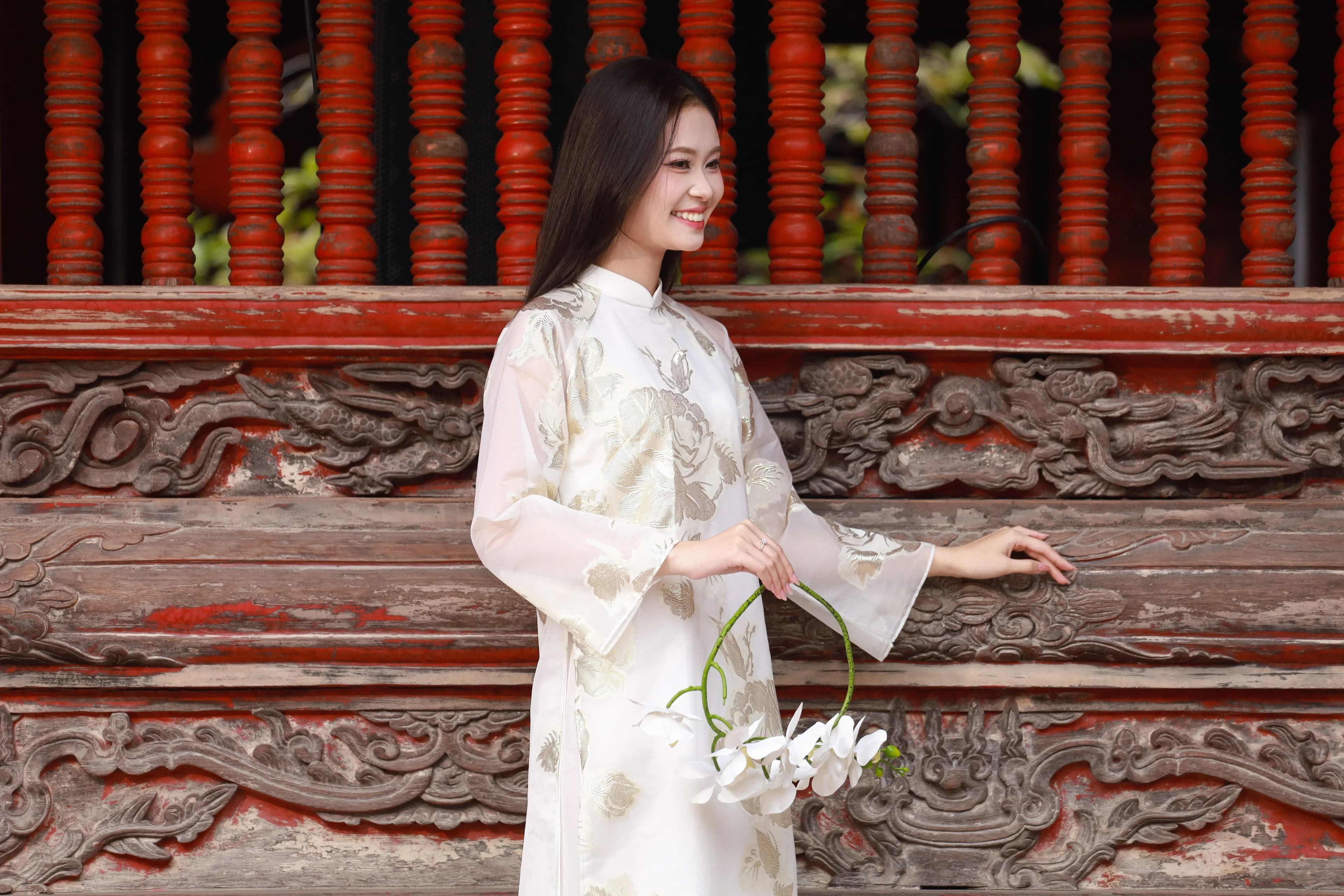 Người phụ nữ đội nón quai thao mặc áo dài lụa truyền thống Việt Nam